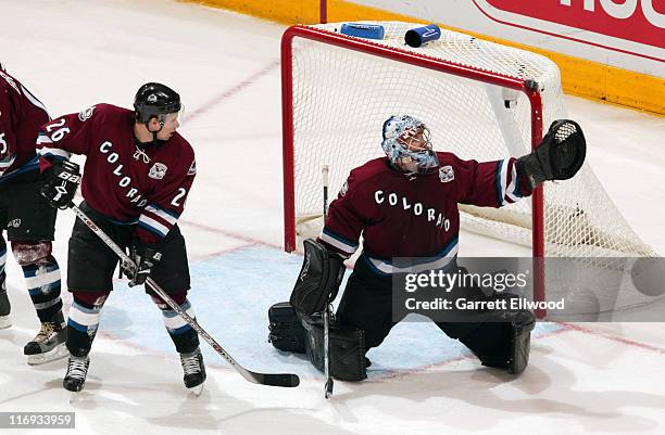 John-Michael Liles and goalie David Aebischer of the Colorado Avalanche watch a puck bounce off the pipe during the game against the Vancouver...