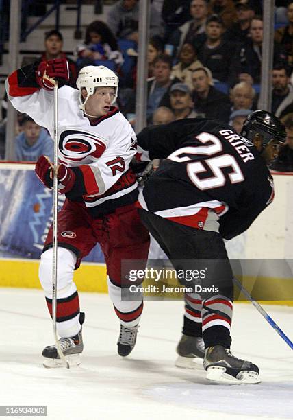 Carolina Hurricanes' Eric Staal avoids a check by Mike Greer of the Buffalo Sabres during a game against the Buffalo Sabres at the HSBC Arena in...