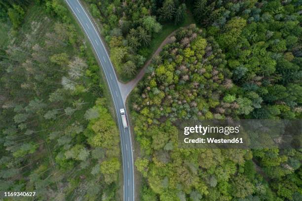 aerial view of rural road through forest, franconia, bavaria, germany - 2019 truck stock-fotos und bilder
