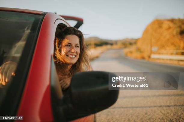 woman on a road trip looking out of car window - mirrors while driving stock pictures, royalty-free photos & images