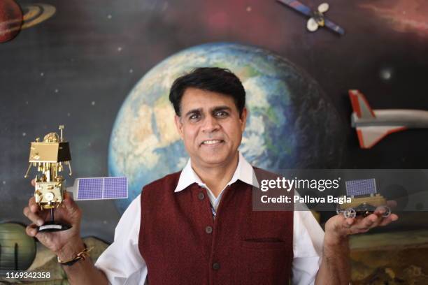 Mr Vivek Singh, engineer and Assistant Scientific Secretary at the Indian space agency, The Indian Space Research Organisation holds a scale model of...