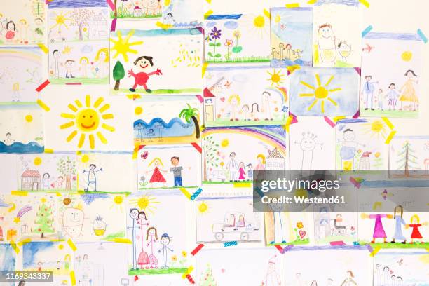 stockillustraties, clipart, cartoons en iconen met child's drawings hanging on wall - childs drawing