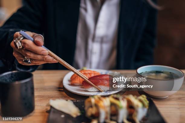 gentleman in sushi bar - japanese food stock pictures, royalty-free photos & images