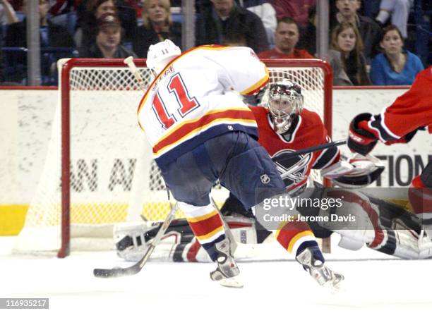 Florida Panthers' Jon Sim lifts the puck over Sabres goalie Ryan Miller's shoulder and in the net during the game at the HSBC Arena in Buffalo, NY,...