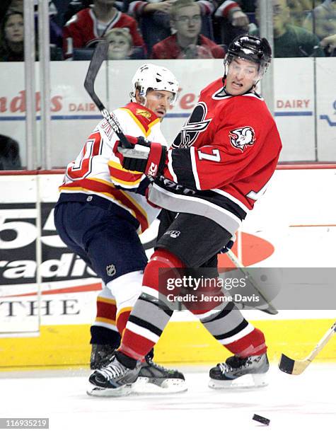 Florida Panthers' Joel Kwiatkowski holds up Sabres' J.P. Dumont from getting to a loose puck during the game at the HSBC Arena in Buffalo, NY,...