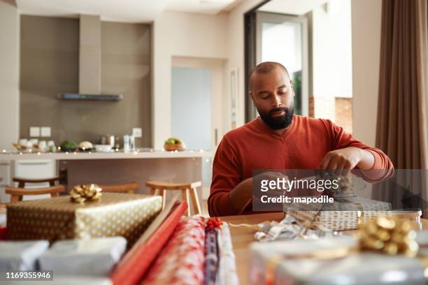 he's got gift wrapping duties covered - gift box stock pictures, royalty-free photos & images