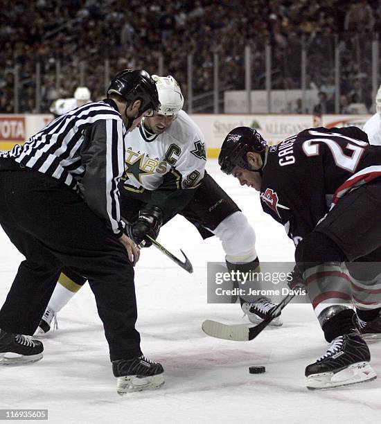 Buffalo Sabres' Paul Gaustad, right, faces off against the Dallas Stars' Mike Modano during a game at the HSBC Arena in Buffalo, NY, December 14,...
