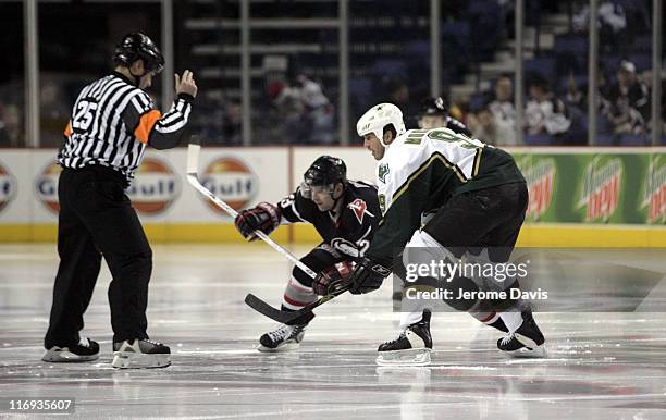 Buffalo Sabres' Paul Gaustad, center, faces off against the Dallas Stars' Mike Modano during a game at the HSBC Arena in Buffalo, NY, December 14,...