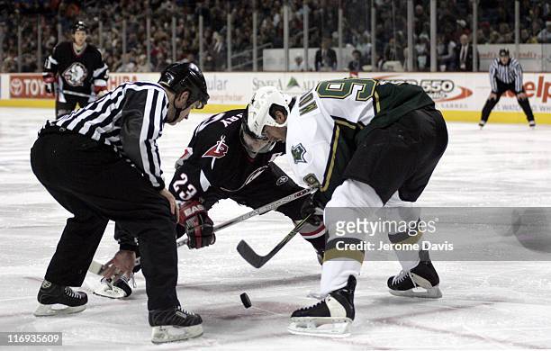 Buffalo Sabres' Chris Drury, center, faces off against the Dallas Stars Mike Modano during a game at the HSBC Arena in Buffalo, NY, December 14, 2005.