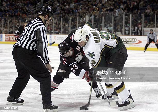 Buffalo Sabres' Chris Drury, center, faces off against the Dallas Stars Mike Modano during a game at the HSBC Arena in Buffalo, NY, December 14, 2005.