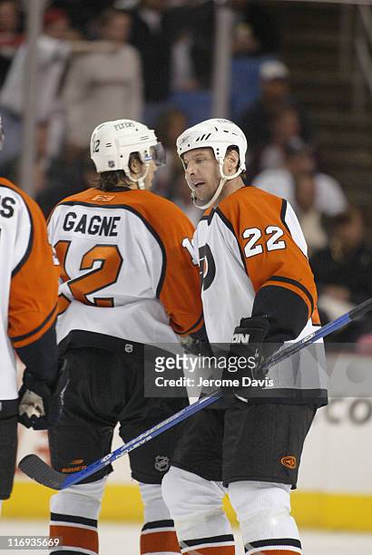 Simon Gagne and Mike Knuble of the Philadelphia Flyers celebrate after a goal during game two playoffs action versus the Buffalo Sabres at the HSBC...