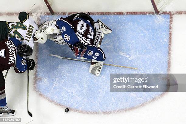 Karlis Skrastins of the Colorado Avalanche holds off Jason Arnott of the Dallas Stars in front of Jose Theodore of the Colorado Avalanche during Game...