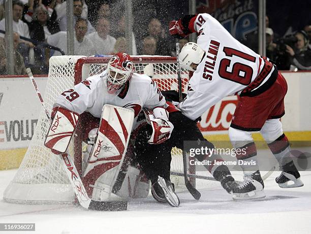 Daniel Briere of the Buffalo Sabres crashes into the net behind Hurricanes goalie Martin Gerber and Cory Stillman during game 3 of the Eastern...