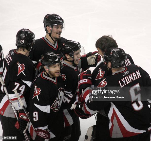 Doug Janek , Jay McKee, Derek Roy, Toni Lydman, and Martin Biron of the Buffalo Sabres congratulate Daniel Briere on his game winning goal in...