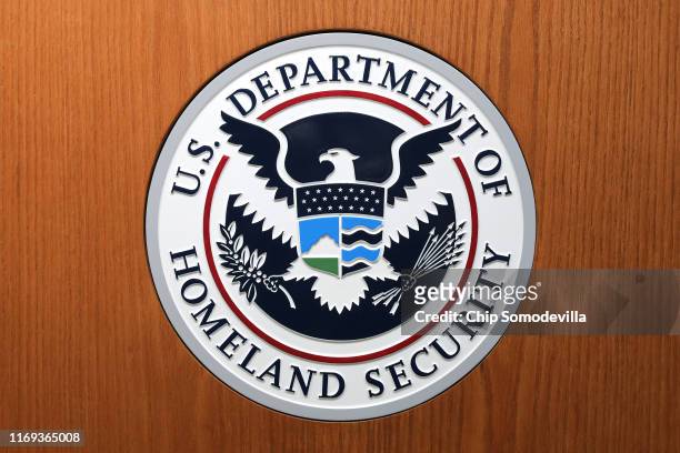 The Department of Homeland Security seal on the podium used by acting Secretary Kevin McAleenan as he announces new rules about how migrant children...