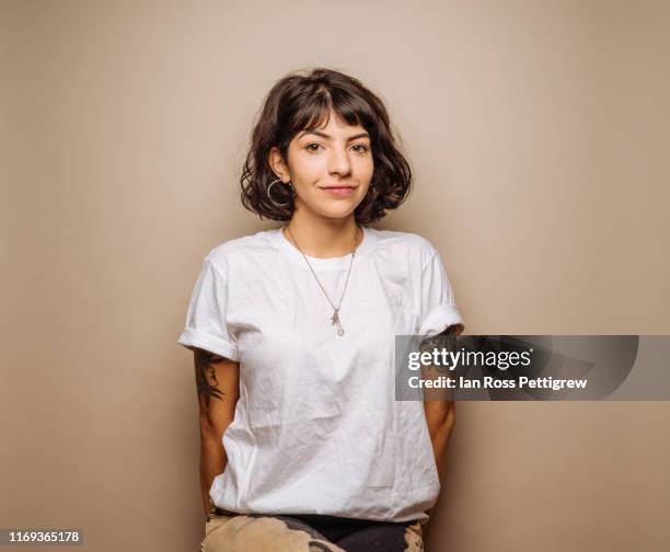 cute young woman in white t-shirt - white fotografías e imágenes de stock