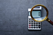 Financal concepts, a calculator showing zero with magnifying glass