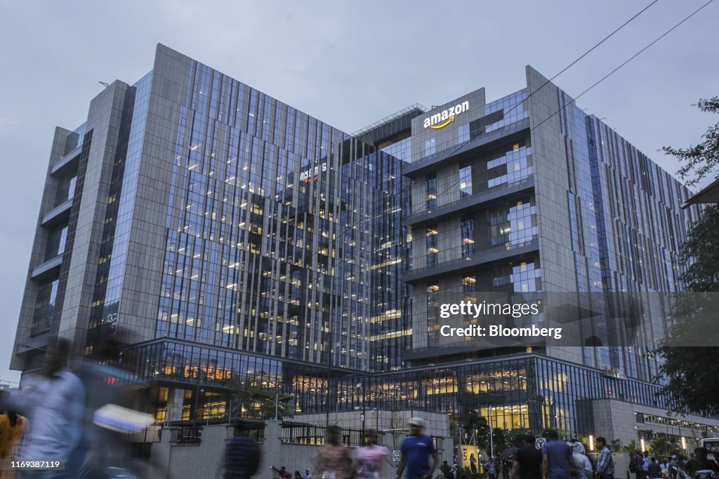 Amazon Inside Pedestrians and employees walk past the Amazon.com Inc. office campus ...
