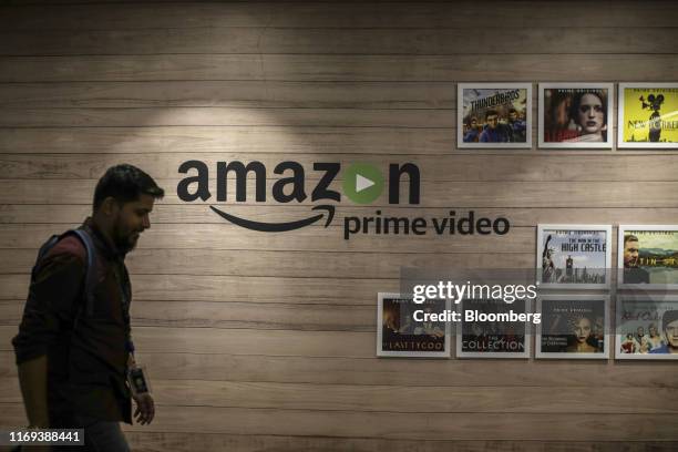 An employee walks past a wall display for Amazon.com Inc.'s Prime Video streaming service at the company's office campus in Hyderabad, India, on...