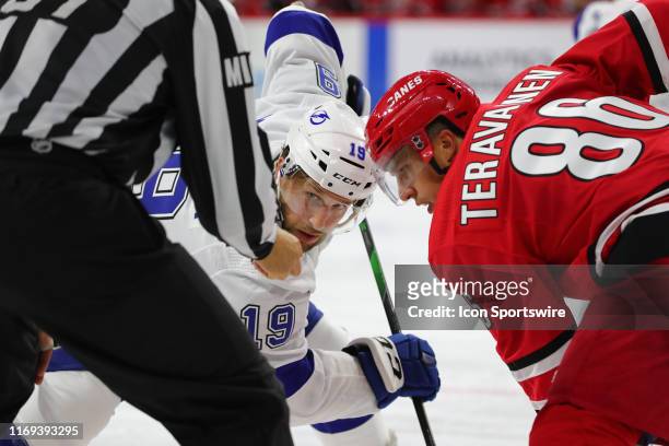 Tampa Bay Lightning forward Chris Mueller and Carolina Hurricanes left wing Teuvo Teravainen eye the puck to face off during the 3rd period of the...