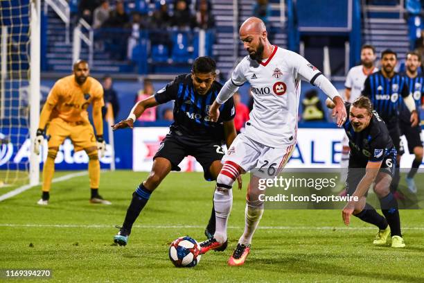 Montreal Impact midfielder Shamit Shome tries to stop Toronto FC defenceman Laurent Ciman from gaining control of the ball during the Toronto FC...