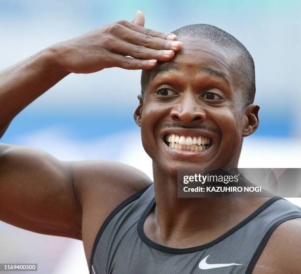 American world record holder Tim Montgomery smiles as he finishes first in the men's 100 meters at the IAAF Japan Grand Prix in Osaka's Nagai...