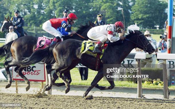 Sarava , with jockey Edgar Prado aboard, crosses the finish line ahead of Medaglia d'Oro to win the 134th Belmont Stakes 08 June in Elmont, NY....