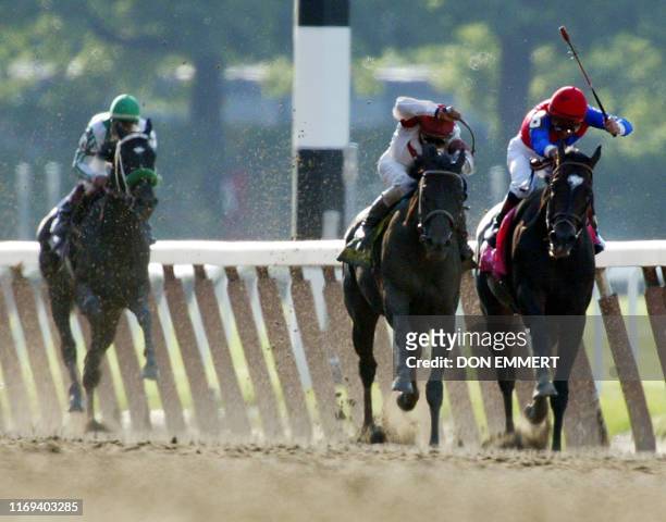 Sarava and Medaglia d'Oro fight toward the finish line as War Emblem trials in the background in the 134th Belmont Stakes 08 June 2002 in Elmont, NY....
