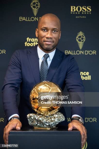 Former Ivory Coast international football player Didier Drogba and ambassador for the 2019 edition of the Ballon d'Or poses with the trophy, during...