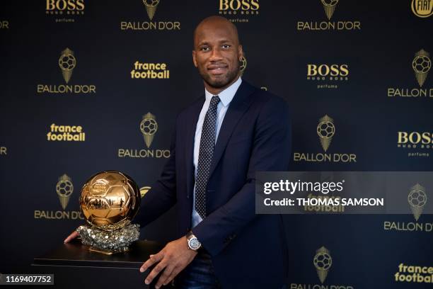 Former Ivory Coast international football player Didier Drogba and ambassador for the 2019 edition of the Ballon d'Or poses with the trophy, during...