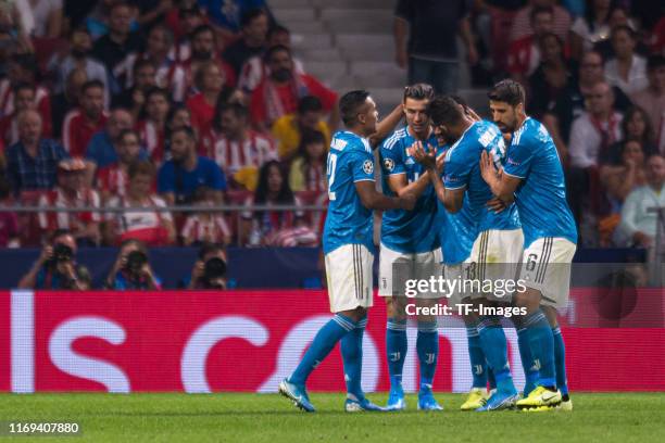 Juan Cuadrado of Juventus celebrates his team's first goal 1:0 with teammates during the UEFA Champions League group D match between Atletico Madrid...