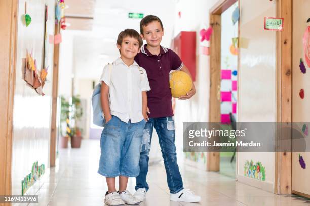 pupils in school hall - two young arabic children only indoor portrait stock-fotos und bilder