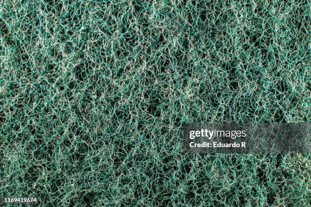 rough texture of green scourer - porous stock pictures, royalty-free photos & images