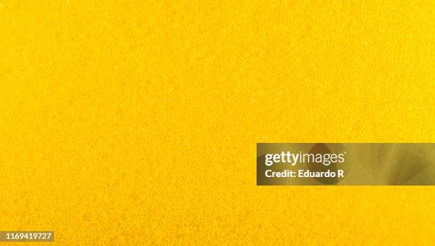 rough texture of yellow sponge with holes - domestic bathroom - fotografias e filmes do acervo