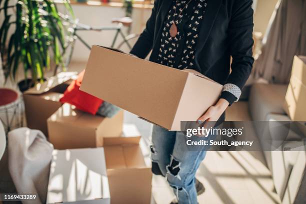 woman moving in into new apartment - college apartment stock pictures, royalty-free photos & images