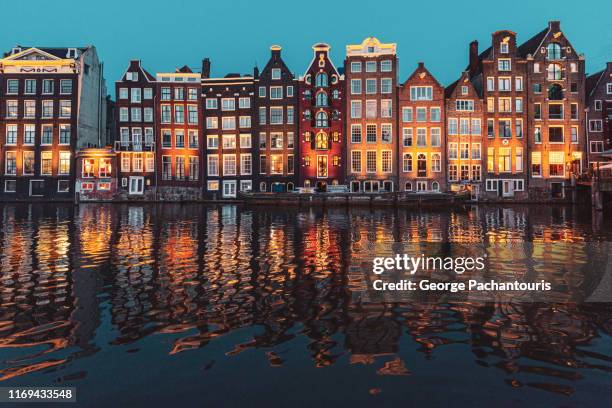 row of houses in amsterdam at dusk - noord holland landschap stockfoto's en -beelden