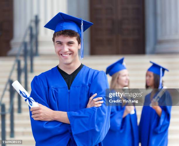 young teenage man celebrating graduation in high school graduation ceremony - graduation gown stock pictures, royalty-free photos & images