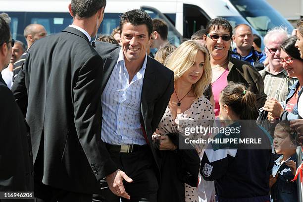 French football player Gregory Coupet and his wife arrive to attend the wedding of French football player Sidney Govou and Clemence Catherin on June...