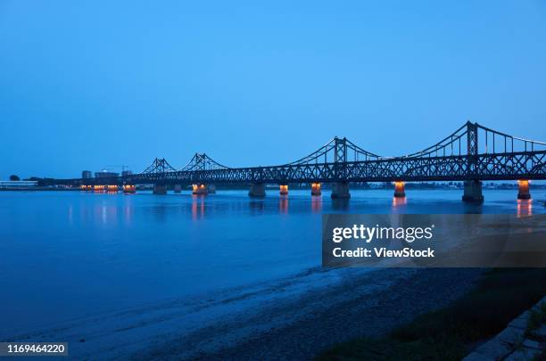 dandong yalu river bridge - liaoning province stock pictures, royalty-free photos & images