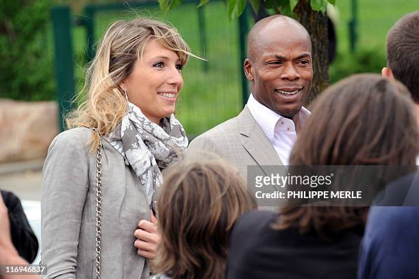 French football player Sylvain Wiltord and his companion arrive to attend the wedding of French football player Sidney Govou and Clemence Catherin on...