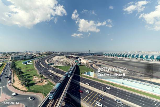 aerial view of airport terminal with cloudy sky in dubai - airport traffic stockfoto's en -beelden