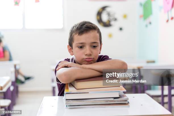 serious boy in school - arab student kids photos et images de collection