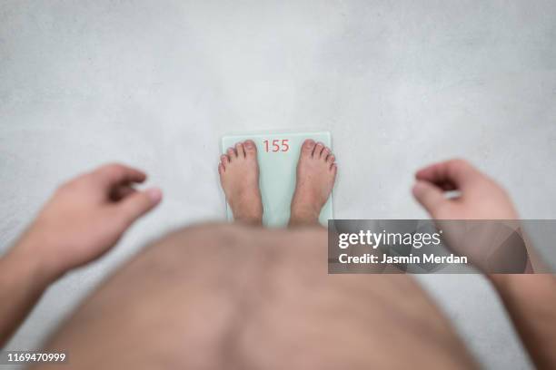 fat man on scale - fat loss stock pictures, royalty-free photos & images