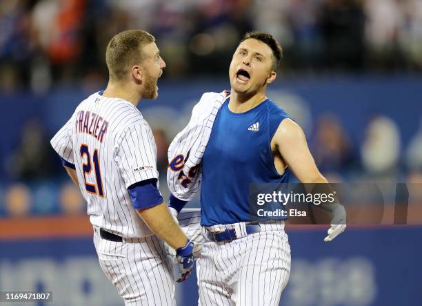 Todd Frazier and J.D. Davis of the New York Mets celebrate the win over the Cleveland Indians at Citi Field on August 21, 2019 in the Flushing...