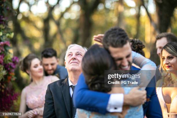 emotional groom being congratulated by the wedding guests - crying sibling stock pictures, royalty-free photos & images