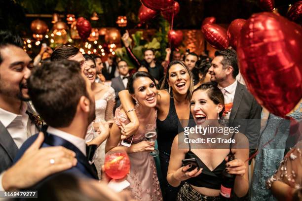groom and wedding guests laughing during party - wedding ceremony stock pictures, royalty-free photos & images