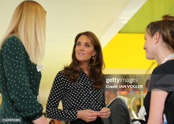 Britain's Catherine, Duchess of Cambridge gestures during her visit to the Sunshine House Children and Young People's Health and Development Centre...