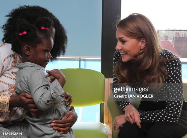 Britain's Catherine, Duchess of Cambridge gestures during her visit to the Sunshine House Children and Young People's Health and Development Centre...