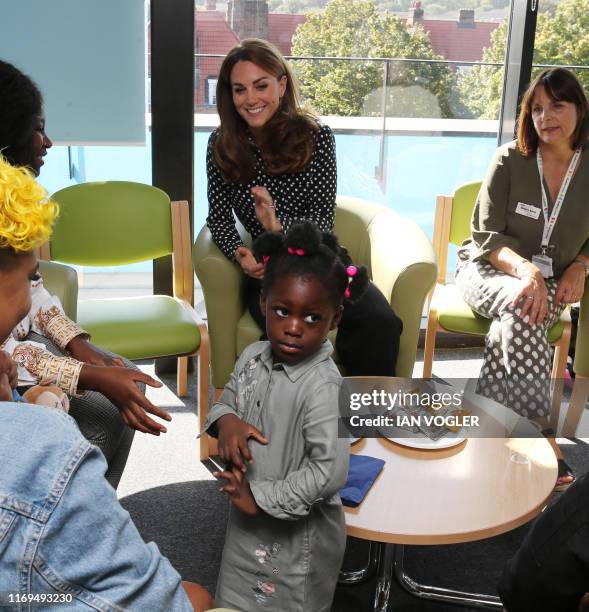 Britain's Catherine, Duchess of Cambridge gestures during her visit to the Sunshine House Children and Young People's Health and Development Centre...