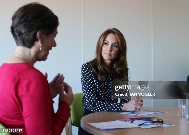 Britain's Catherine, Duchess of Cambridge chats during her visit to the Sunshine House Children and Young People's Health and Development Centre to...